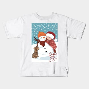 Cute wintery landscape with a Child making a snowman out in the snow Kids T-Shirt